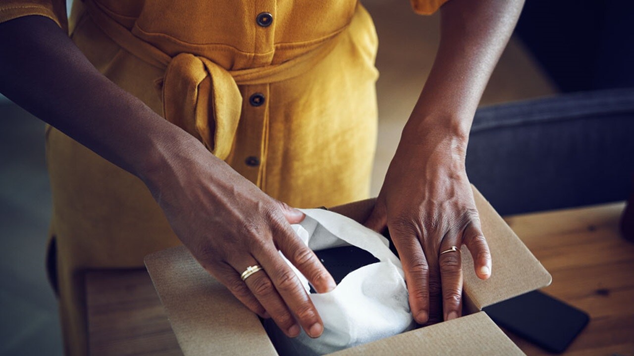 Woman’s hands opening parcel 