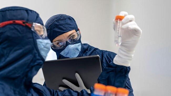 Two pharmaceutical workers examining a new medicine