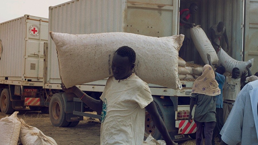 Men unloading a truck containing dry cargo in Africa.