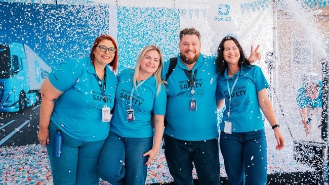 A group of four Maersk employees get celebrated with confetti
