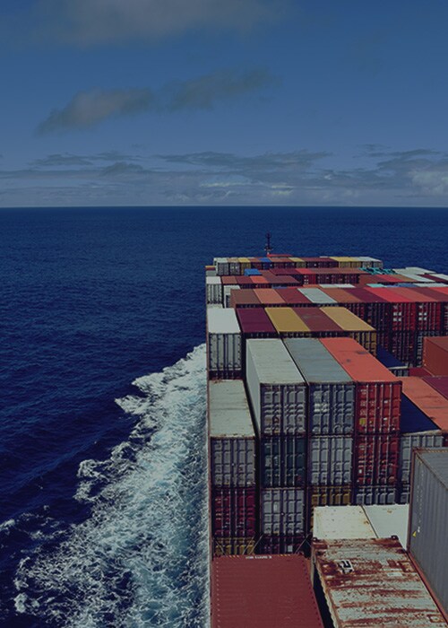 A cargo ship transporting containers across the ocean.